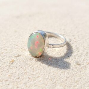 OVAL OPAL AND HALLMARKED SILVER RING.