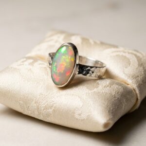 OPAL RING, OVAL OPAL SET IN FINE AND STERLING SILVER WITH HAND CRAFTED SHANK AND BEZEL