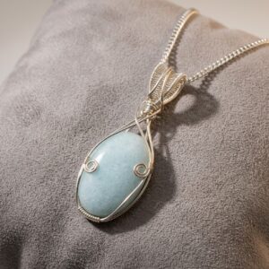 Handmade Caribbean Calcite necklace with soft blue and cream crystal tones, silver-plated wire wrapping and an 18-inch chain.