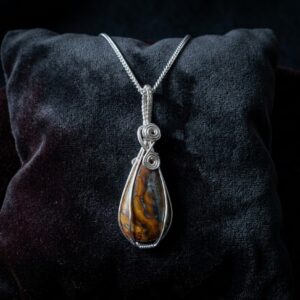 Handmade Inferno Jasper necklace with fiery red and earthy patterned stone, silver-plated wire wrapping and an 18-inch chain.