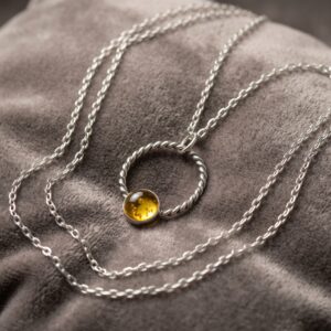 Handmade citrine necklace with an 8mm golden citrine cabochon set in sterling silver with a large twisted silver loop.