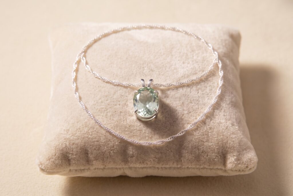 5ct faceted green amethyst necklace in a sterling silver claw setting with a 20-inch Singapore chain.