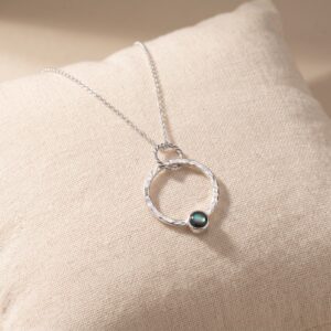 Handmade abalone shell necklace with a 6mm iridescent cabochon in a large sterling silver hoop on an 18-inch chain.