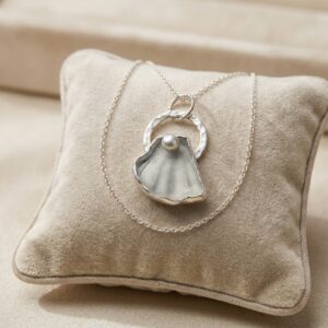 Unique Cornish sea glass necklace with a naturally shell-shaped piece set in sterling silver on an 18-inch chain.